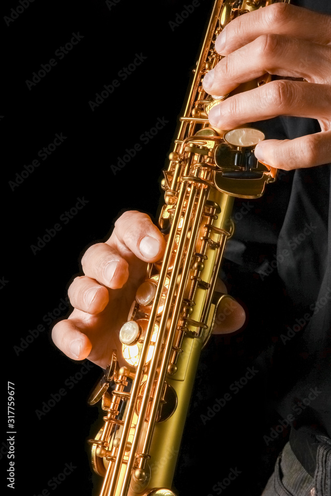 Fototapeta premium soprano saxophone in hands on a black background