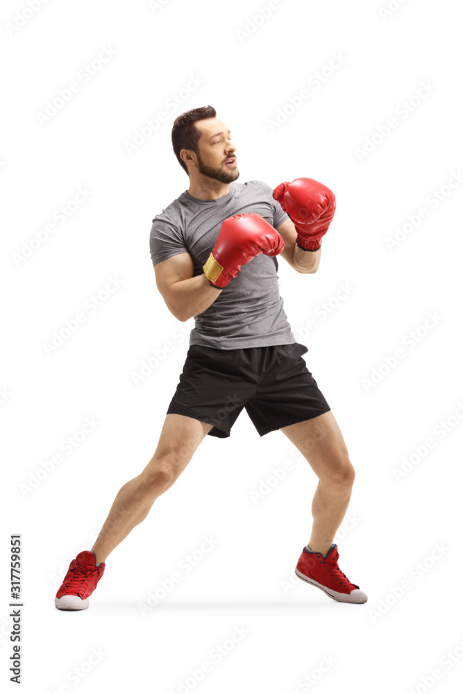 Young man with boxing gloves standing in a guard position