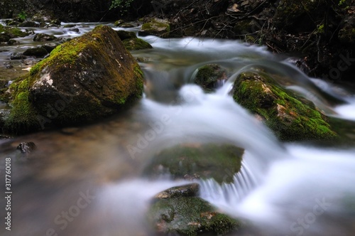 Stones lie in water in mountain stream