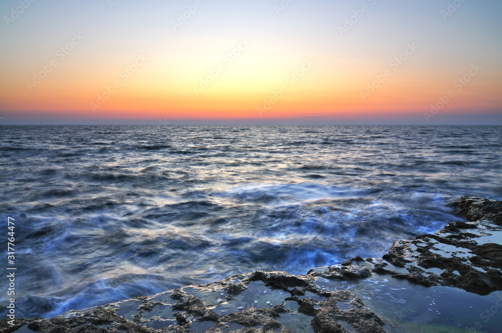 Beautiful pink sunset and water stones with green moss over Black sea Beautiful pink sunset and water stones with green moss over Black sea