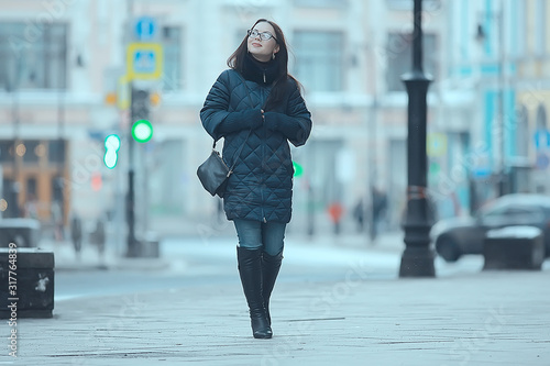 girl in a coat in the winter city / concept of fatigue stress christmas chores