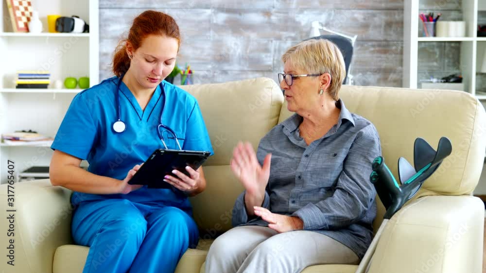 Female doctor holding tablet computer in nursing home Female doctor holding tablet computer in nursing home