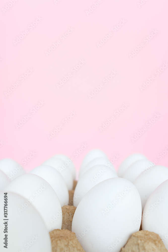 White eggs on a colored background in a box, minimalistic easter card