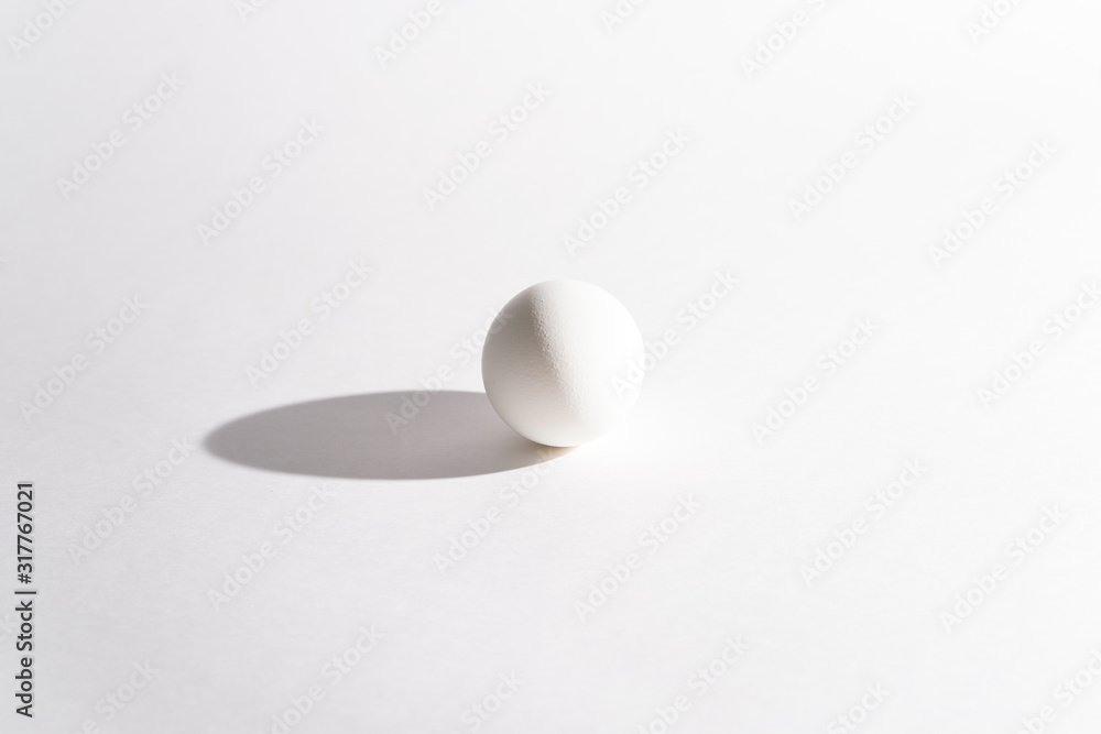 White egg on a white background in the center. Modern easter card. Design, visual art, minimalism White egg on a white background in the center. Modern easter card. Design, visual art, minimalism