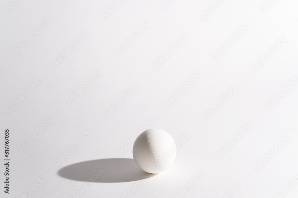 White egg on a white background in the center. Modern easter card. Design, visual art, minimalism White egg on a white background in the center. Modern easter card. Design, visual art, minimalism