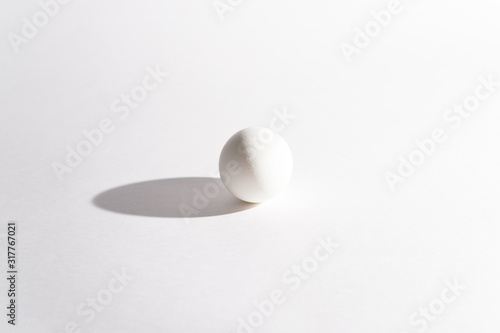 White egg on a white background in the center. Modern easter card. Design  visual art  minimalism
