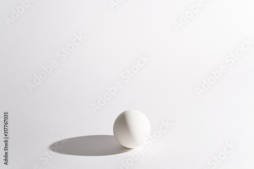 White egg on a white background in the center. Modern easter card. Design  visual art  minimalism