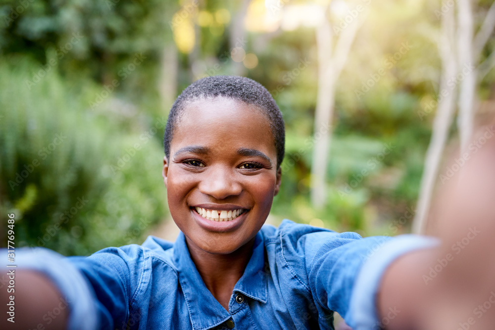 Young African American woman smiling and taking selfies outdoors Young African American woman smiling and taking selfies outdoors