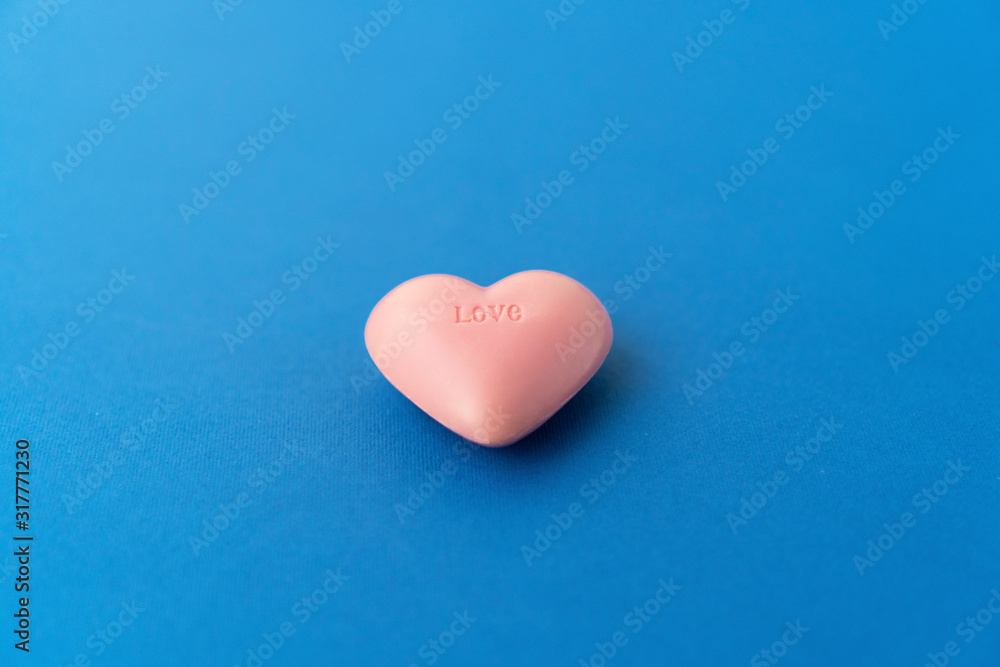 Top view composition of pink heart on colorful background. Romantic relationship concept. Romantic Valentines Mother's Day Charity concept. Greeting card poster template with copy space Top view composition of pink heart on colorful background. Romantic relationship concept. Romantic Valentines Mother's Day Charity concept. Greeting card poster template with copy space