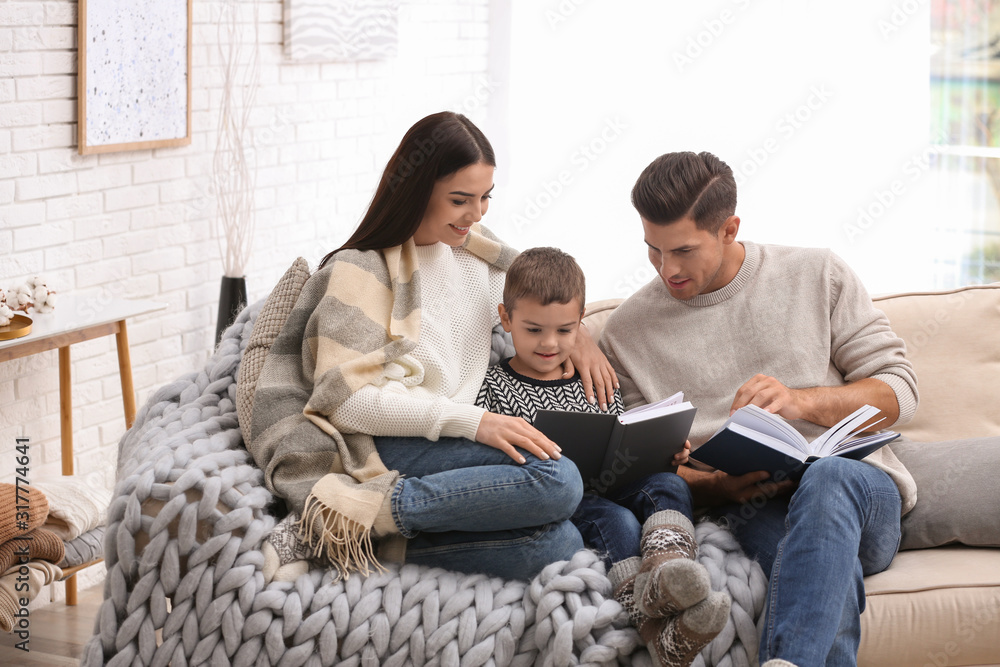 Happy family with little son reading books at home. Winter vacation Happy family with little son reading books at home. Winter vacation