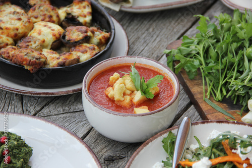 Georgian national cuisine,.food on a wooden table with fresh vegetables and herbs