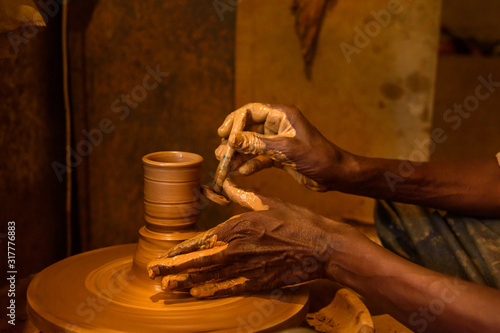 Obraz na płótnie Indian potter making clay pots on pottery wheel in Pottery town is old place. Bangalore. India w salonie