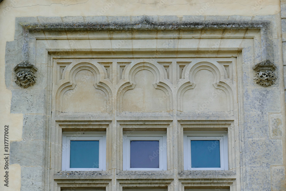 Closeup architectural details of ancient historic castle or chateau in France - ornate windows with colored glass