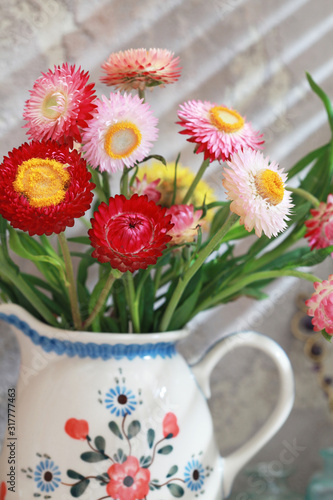 Wallpaper Mural Сolorful everlasting bouquet in a ceramic jud. Everlast or Helichrysum arenarium, and as immortelle. Selective focus Torontodigital.ca
