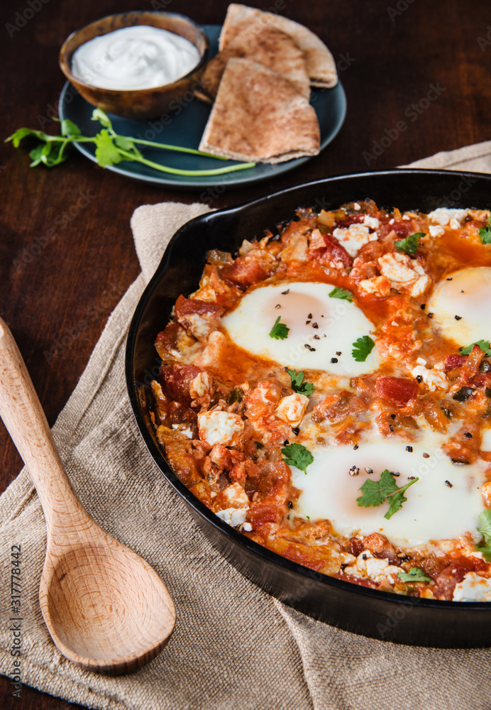 Cast iron skillet with Shakshuka eggs Cast iron skillet with Shakshuka eggs