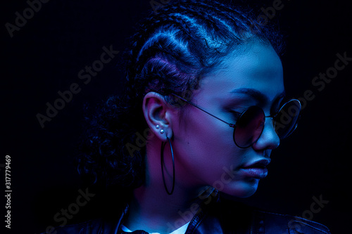 Fashion young African girl black woman hold stylish pink glasses looking at the camera isolated on a black Studio background, horizontal banner for website design, portrait, copy space