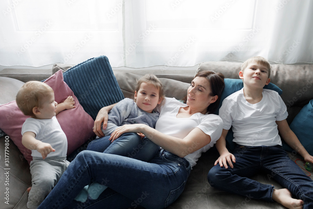 Family relaxing on couch in living room at home Family relaxing on couch in living room at home