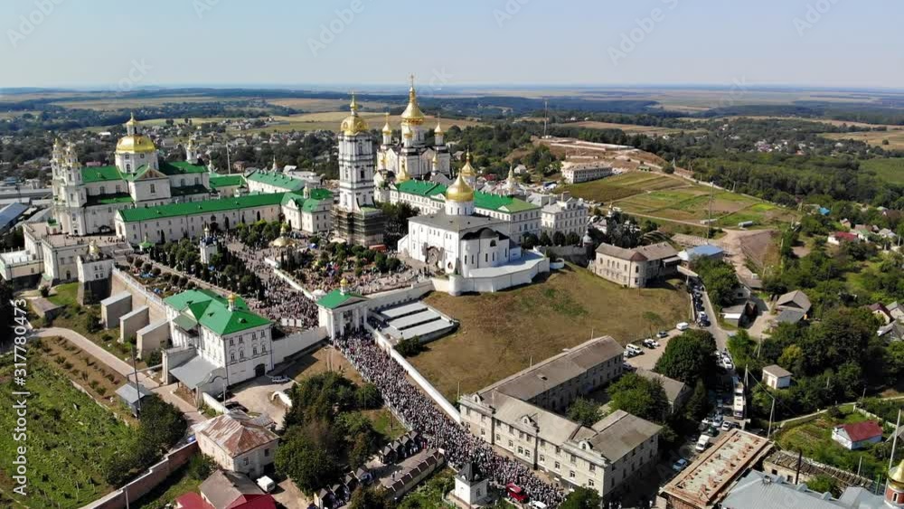 Top view of the Pochaev Lavra at the moment when a lot of people enter it. Orthodox procession in the monastery. Top view of the Pochaev Lavra at the moment when a lot of people enter it. Orthodox procession in the monastery.