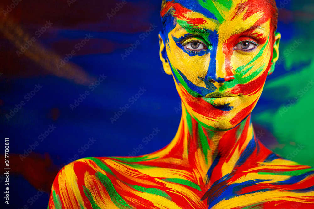 Color art face of woman for inspiration. Closeup portrait of the bright beautiful girl with colorful make-up and bodyart.