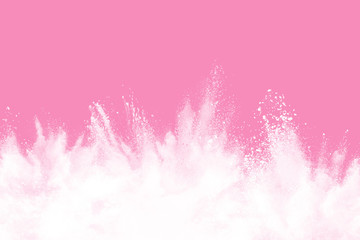 White powder explosion isolated pink background.