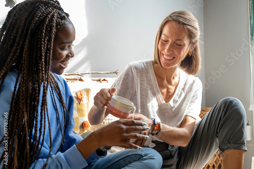 Two friends drinking tea at home