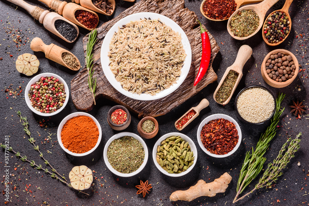 Spices and herbs over black stone background. Top view with free space for menu or recipes Spices and herbs over black stone background. Top view with free space for menu or recipes