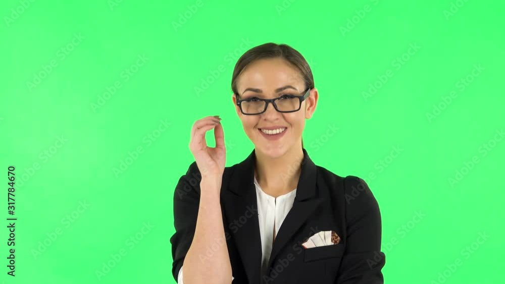 Woman coquettishly smiling and laughing while looking at camera. Green screen Woman coquettishly smiling and laughing while looking at camera. Green screen