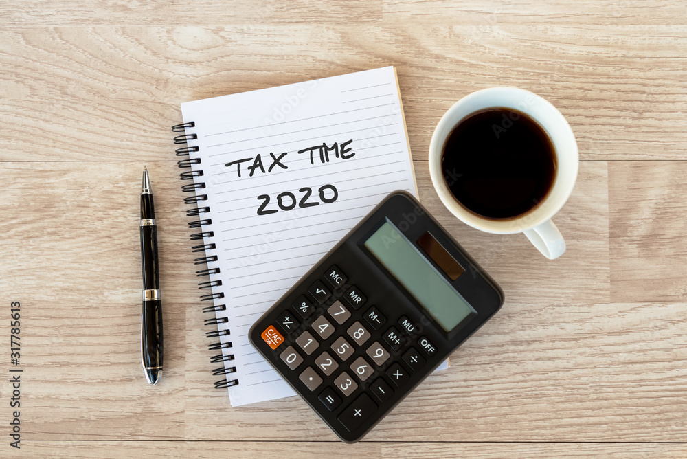 Business finance Concept - Tax time 2020 text on Note pad Business finance Concept - Tax time 2020 text on Note pad