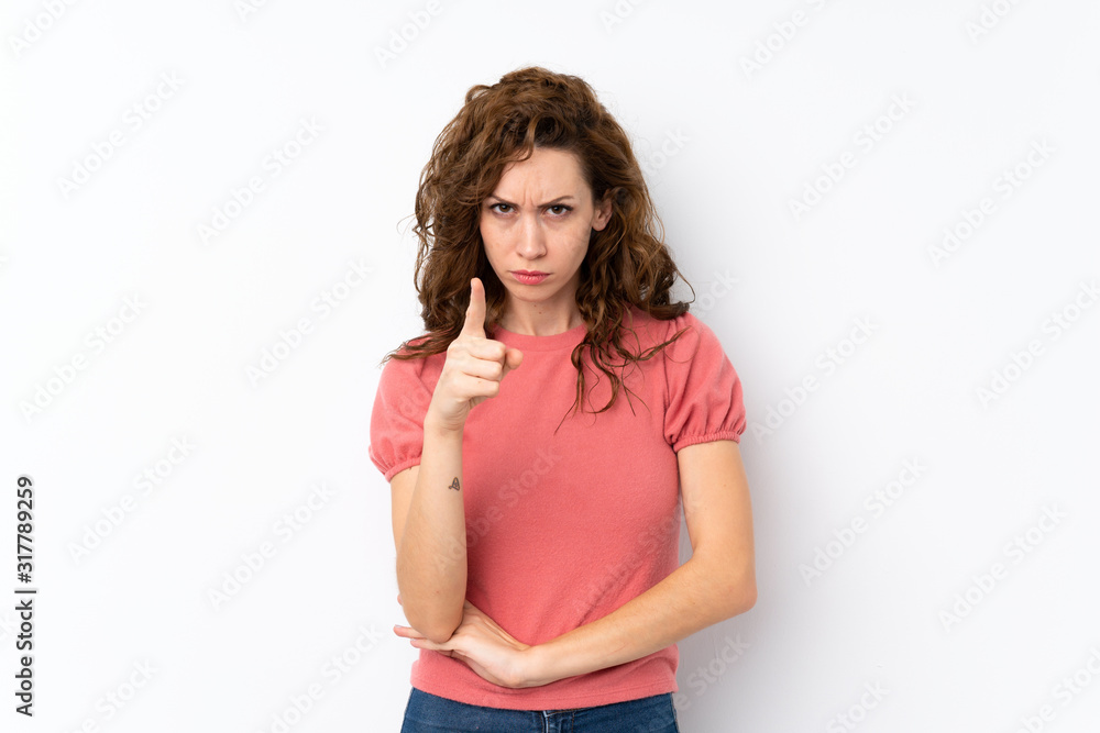Young pretty woman over isolated background frustrated and pointing to the front Young pretty woman over isolated background frustrated and pointing to the front