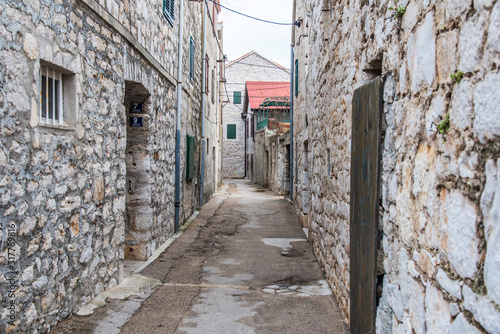 Narrow street in the fishing village, Murter, Croatia, Europe © precinbe