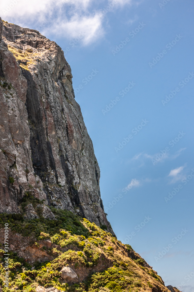 Stanley, Tasmania, Australia - December 15, 2009: Land side ofThe Nut volcanic plug under blue cloudscape. Stanley, Tasmania, Australia - December 15, 2009: Land side ofThe Nut volcanic plug under blue cloudscape.