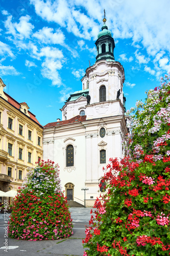 Prague in Summer with beautiful red and white flower arrangements by St. Nikolas Church at Stare Mesto or Old Market Square in Prague, Czech Republic in Summer