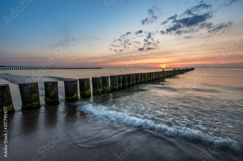 Baltic sea seascape at sunset  Poland  wooden breakwater and waves