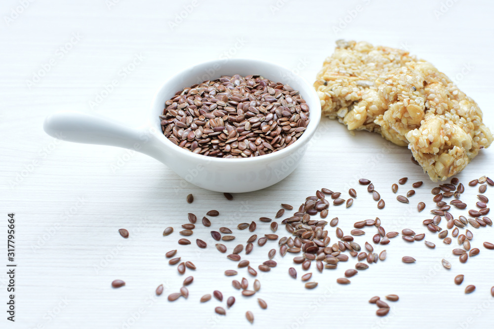Natural sesame seeds on wooden background Natural sesame seeds on wooden background
