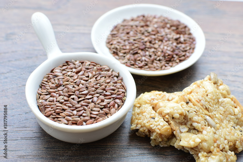 Natural sesame seeds on wooden background Natural sesame seeds on wooden background