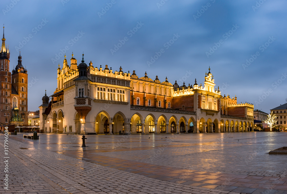 Krakow, Poland, illuminated cloth hall on the main square in the morning