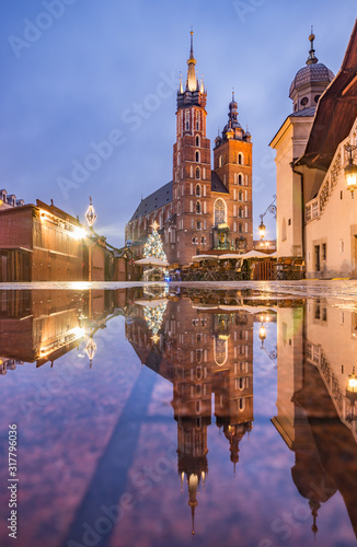 Krakow, Poland, St Mary's church in the morning, reflection in the water after rainy night