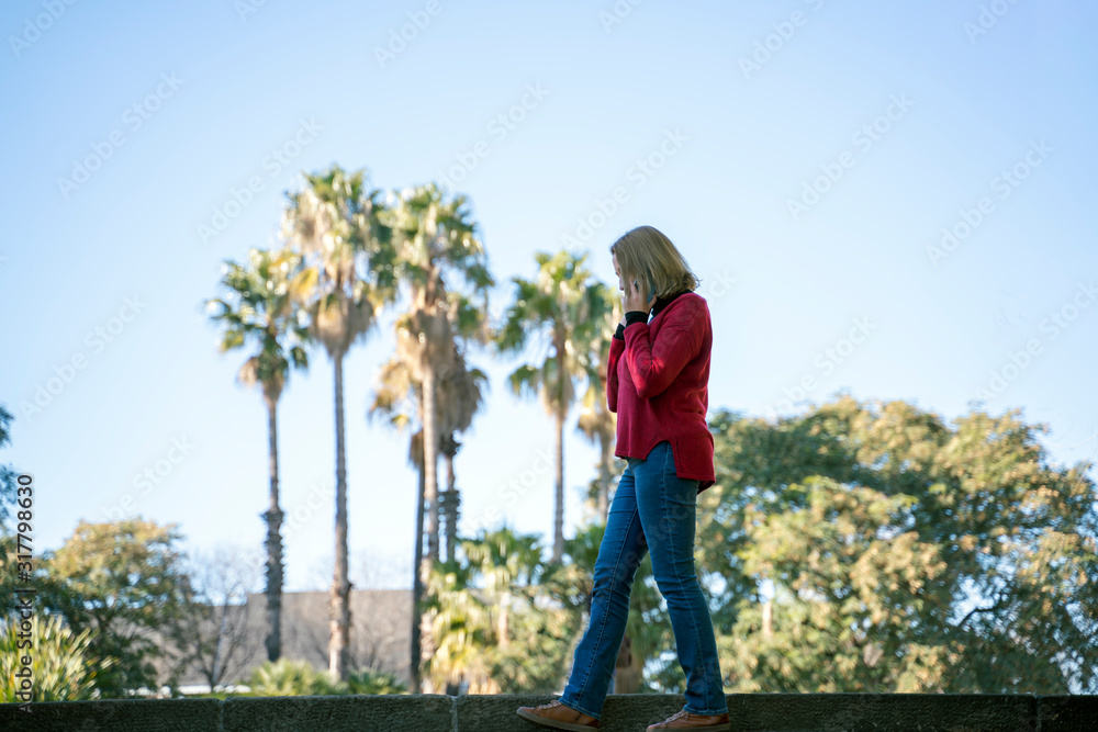 Attractive blonde woman using her smartphone Attractive blonde woman using her smartphone