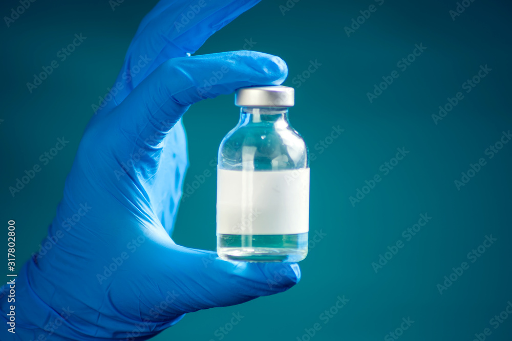 A doctor holding a bottle with vaccine. Medicine and healthcare concept A doctor holding a bottle with vaccine. Medicine and healthcare concept