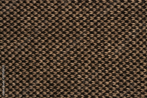 The background is knitted from threads. Brown arrows on a black background