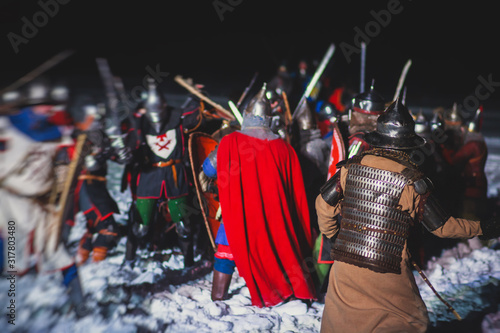 Medieval battle scene with cavalry and infantry, fight between crusaders and knights during historical reenactment