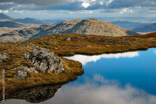 Beinn a'Chroin's dramatic rocky features reflecting in a small pond. Beinn a'Chroin is a small munro in Scottish Highlands to the south of Crianlarich.