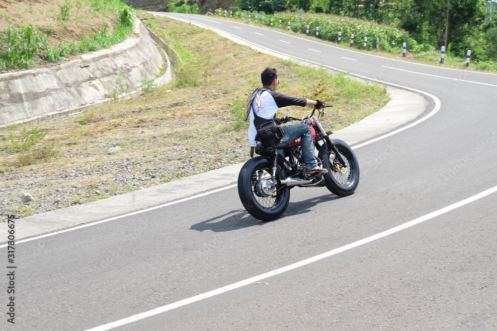 Man riding a motorcycle on the highway Man riding a motorcycle on the highway