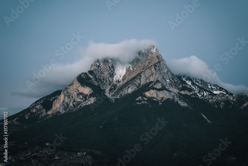 Snowcapped mountain peak against clear sky during sunrise