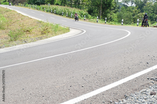 Man riding a classic motorcycle on highway of mountain © YoannesBaskoro