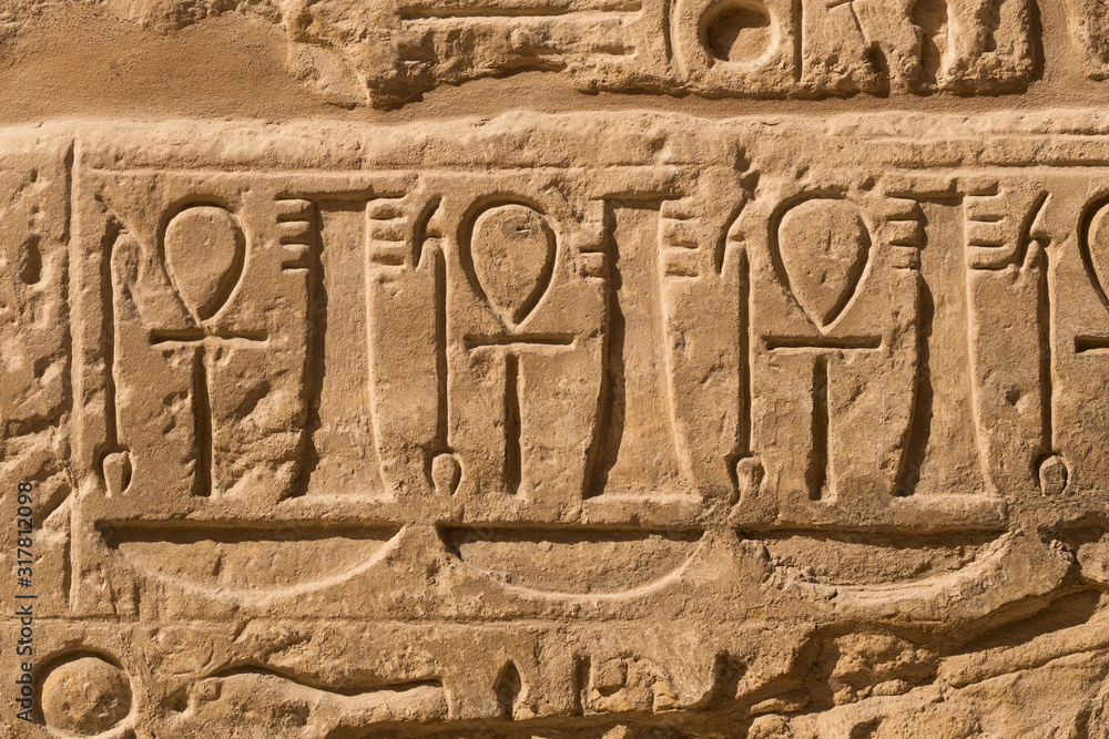 Karnak Temple, complex of Amun-Re. Embossed hieroglyphics on walls. Luxor Governorate, Egypt. Ankh is an ancient Egyptian hieroglyphic symbol that means the word 