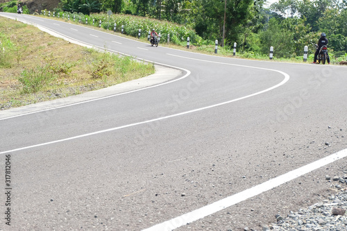 Man riding a classic motorcycle on highway of mountain