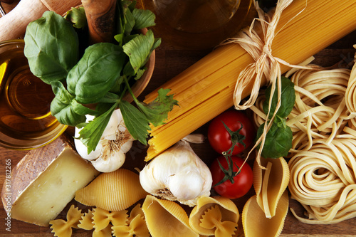 Obraz na plátně Pasta, vegetables, herbs and spices for Italian food on rustic table