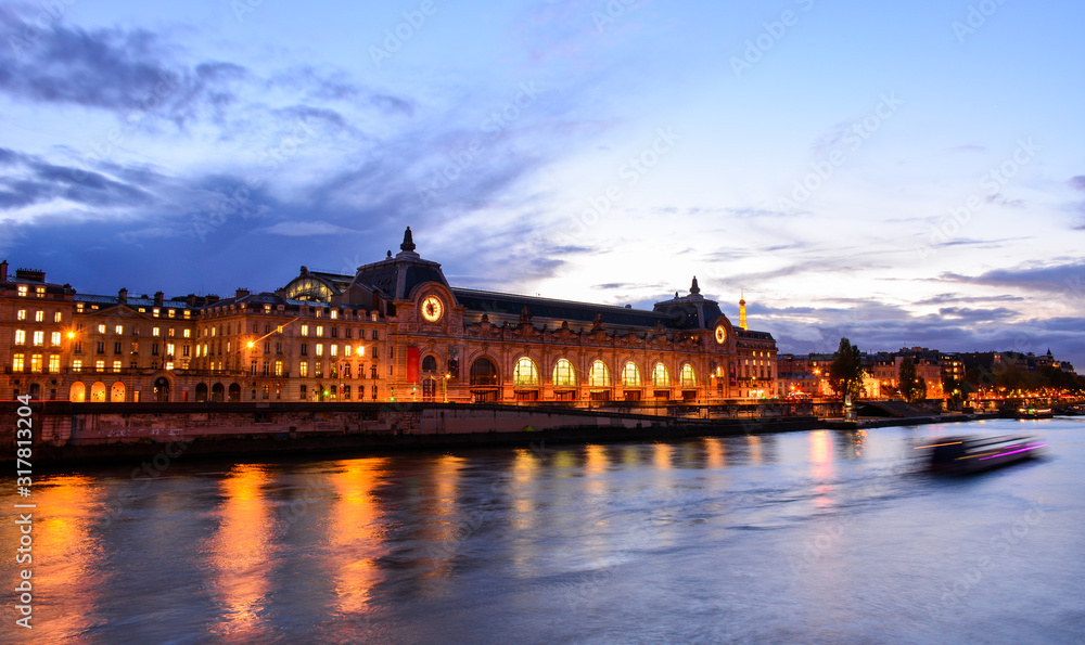 Fototapeta premium Blue night view of the beautiful river Seine in Paris, France, with Musee d'Orsay, one of the major art museums in the world with the best impressionism collection