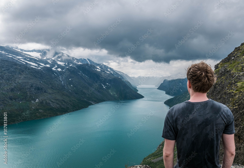 hiker looking out over Gjende lake on the besseggen ridge Norway